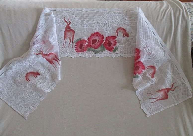 An unusual `half mast` lace curtain with with coloured proteas and animals