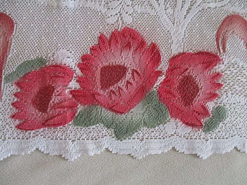 An unusual `half mast` lace curtain with with coloured proteas and animals