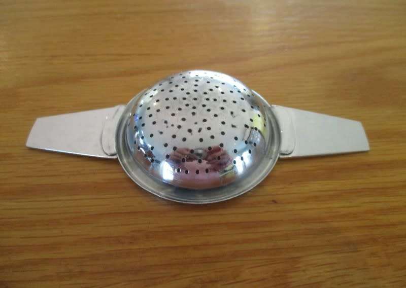Midwinter, England tea strainer with porcelain base