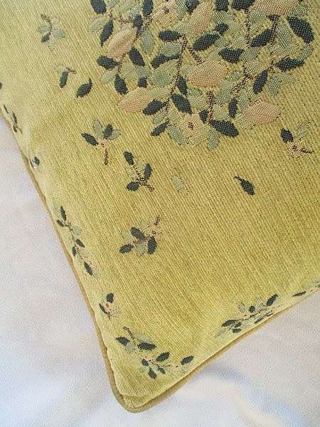 A vintage tapestry-style cushion with potted tree design