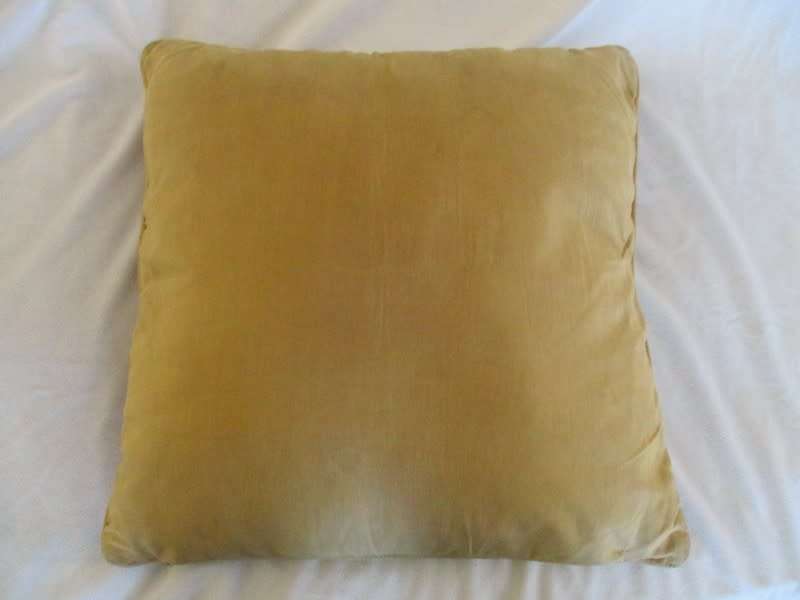 A vintage tapestry-style cushion with potted tree design