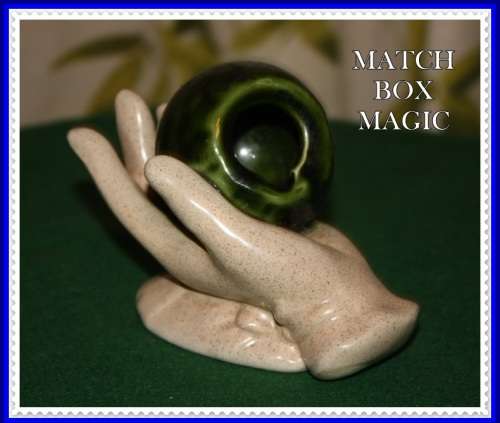HAND HOLDING GREEN ORB ASHTRAY