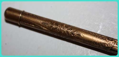 BEAUIFUL HAND ETCHED ITEM VERY OLD WITH INTRICATE DESIGN . I THINK IT IS A RETRACTABLE PENCIL