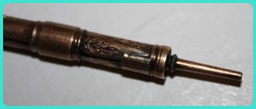 BEAUIFUL HAND ETCHED ITEM VERY OLD WITH INTRICATE DESIGN . I THINK IT IS A RETRACTABLE PENCIL