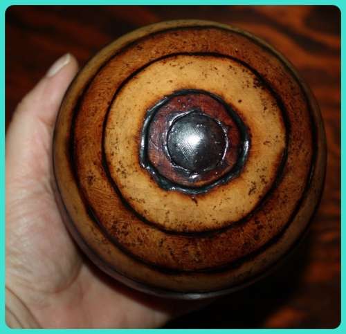 TWO WOODEN ORB DECORATIONS