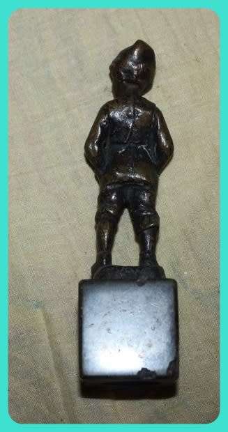 METAL STATUETTE BOY WITH HANDS IN POCKETS