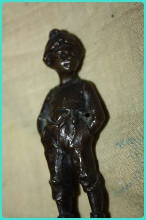 METAL STATUETTE BOY WITH HANDS IN POCKETS