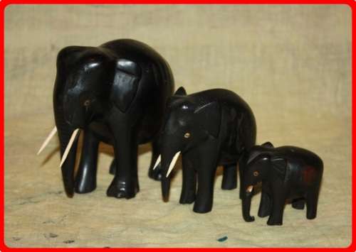 FAMILY OF THREE WOODEN ELEPHANTS
