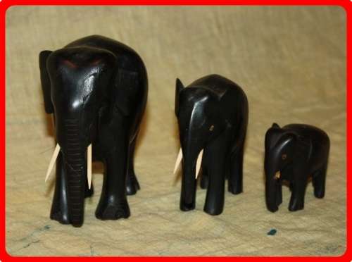 FAMILY OF THREE WOODEN ELEPHANTS
