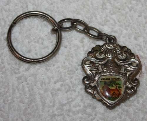 KRUGER NATIONAL PARK SHIELD KEYRING WITH SMALL ENAMEL INSERT DEPICTING A LION