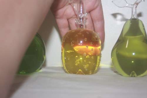 GLASS TRIO OF FRUIT FILLED WITH COLOURED LIQUID APPLE  PEAR AND PINEAPPLE