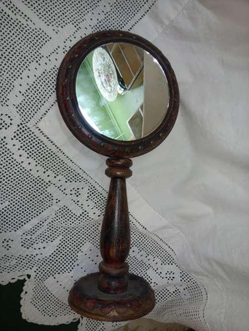 Upright wooden shaving mirror with metalwork decorative detail