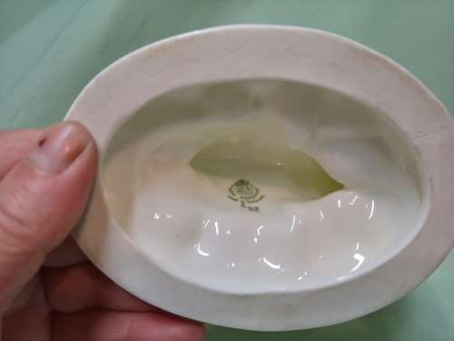 Royal Wocester dolphin supporting a clam shell ornament