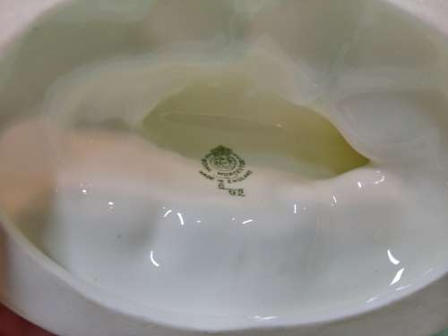 Royal Wocester dolphin supporting a clam shell ornament