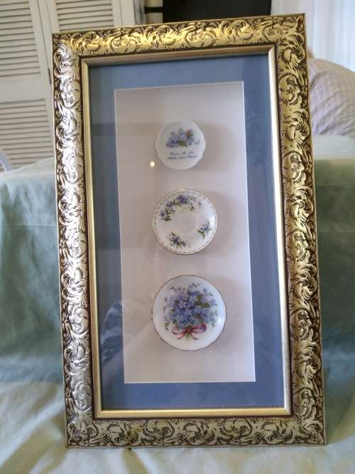 Beautifully framed trio of forget-me-not porcelain pin plates