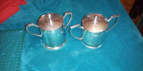 Pair of matching lidded condiment pots. Very elegant. Art deco style handles.