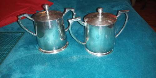 Pair of matching lidded condiment pots. Very elegant. Art deco style handles.