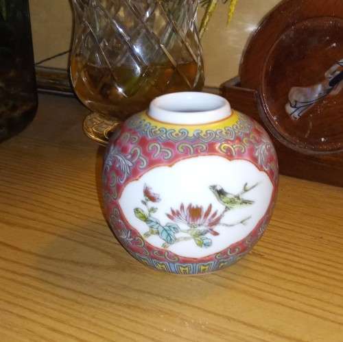 Small oriental ginger jar with pink background no lid.  botenical detail on front and back.