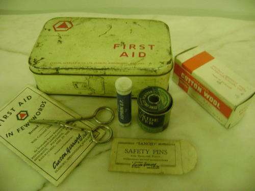 A VERY OLD FIRST AID TIN WITH SOME OF ITS ORIGINAL CONTENTS