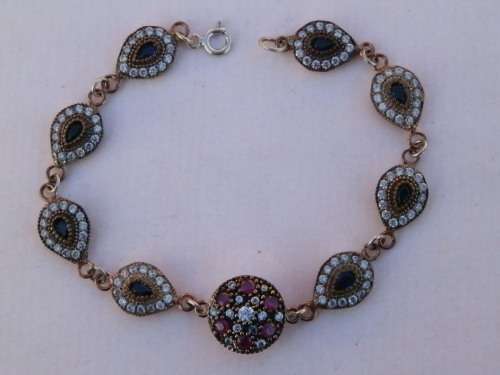 Sterling silver ruby, blue sapphire and topaz bracelet, 19.2 g.