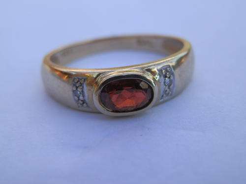 9 ct Gold garnet and diamond ring. Two (2) weeks to pay