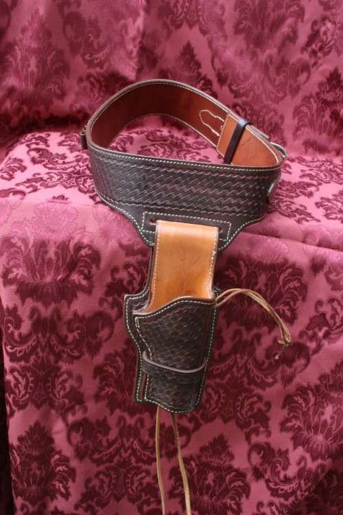 Cowboy belt and holster . Genuine leather