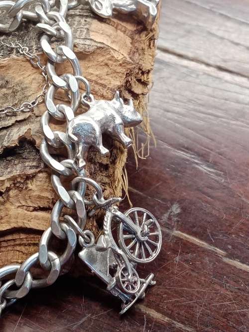 Sterling silver heavy charm bracelet 11 solid charms 265mm long