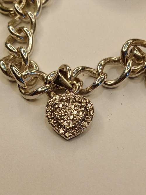 Sterling silver charm bracelet with 11 charms 21cm long