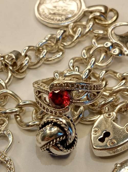 Sterling silver charm bracelet with 11 charms 21cm long