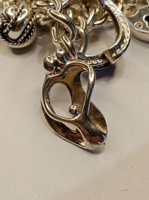 Sterling silver charm bracelet with 11 charms 21cm long