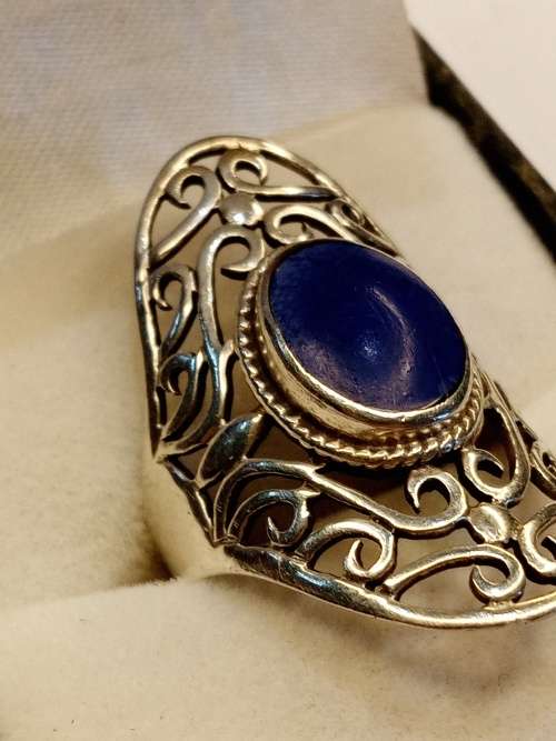 Sterling silver ladies ring with blue stone Size O.5