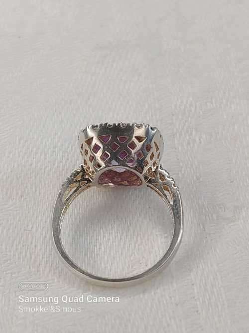 Sterling silver ladies ring with purple violet stone surrounded by cubic zirconia Size: K.5