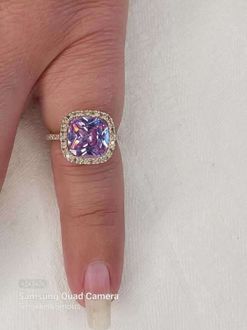 Sterling silver ladies ring with purple violet stone surrounded by cubic zirconia Size: K.5