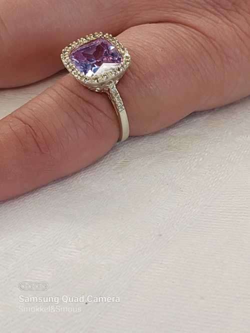 Sterling silver ladies ring with purple violet stone surrounded by cubic zirconia Size: K.5