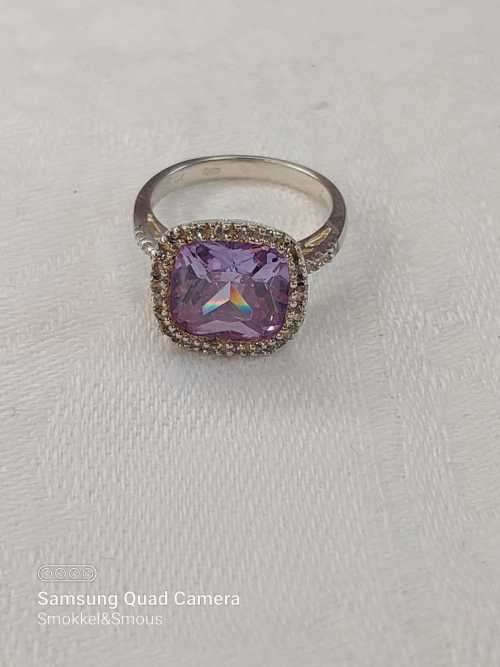 Sterling silver ladies ring with purple violet stone surrounded by cubic zirconia Size: K.5