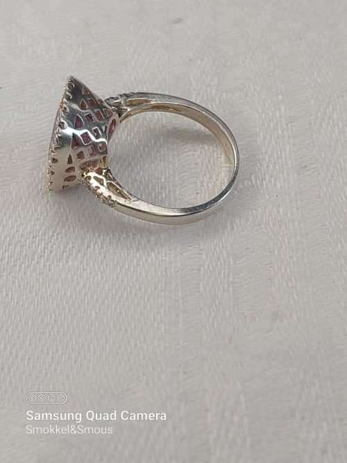 Sterling silver ladies ring with purple violet stone surrounded by cubic zirconia Size: K.5