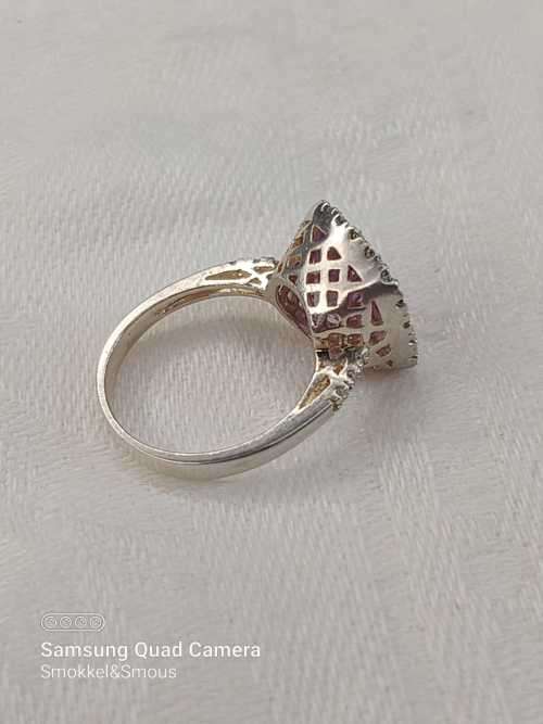 Sterling silver ladies ring with purple violet stone surrounded by cubic zirconia Size: K.5