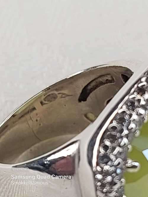 Sterling silver ladies ring with very large green stone surrounded with cubic zirconia Size: M.5