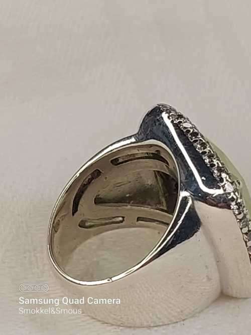 Sterling silver ladies ring with very large green stone surrounded with cubic zirconia Size: M.5