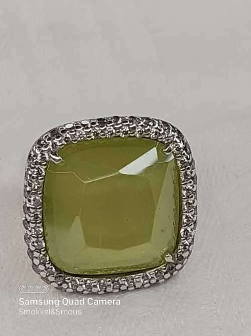Sterling silver ladies ring with very large green stone surrounded with cubic zirconia Size: M.5