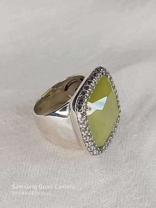 Sterling silver ladies ring with very large green stone surrounded with cubic zirconia Size: M.5