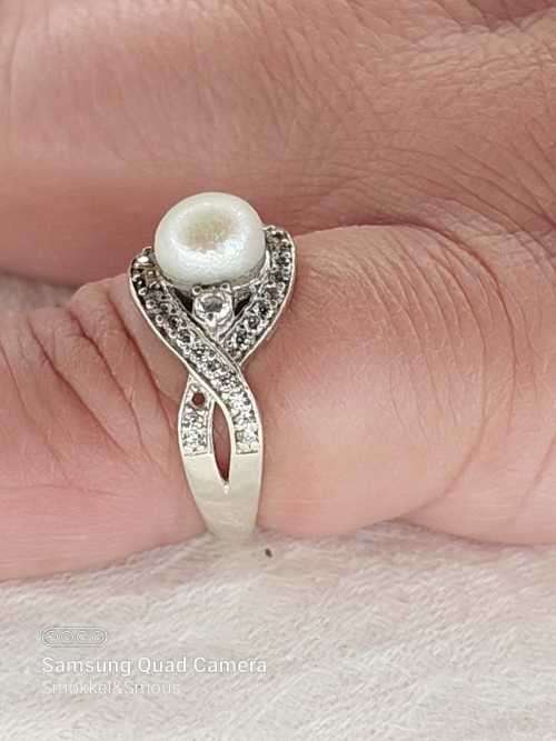 Sterling silver ladies ring with genuine pearl surrounded with cubic zirconia Size: O.5