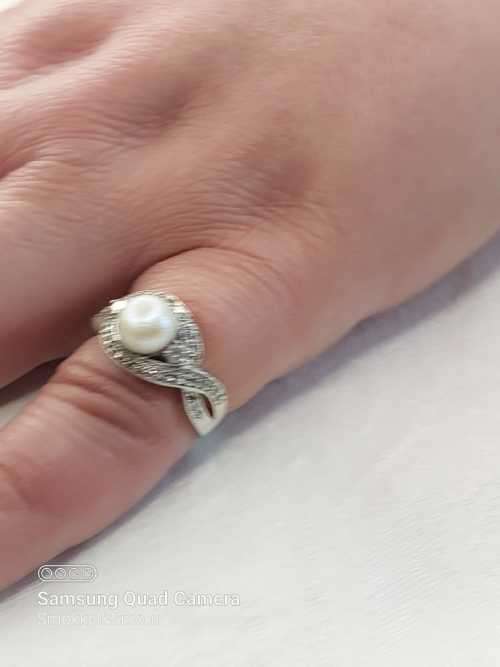 Sterling silver ladies ring with genuine pearl surrounded with cubic zirconia Size: O.5