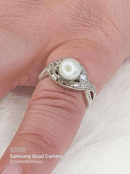 Sterling silver ladies ring with genuine pearl surrounded with cubic zirconia Size: O.5