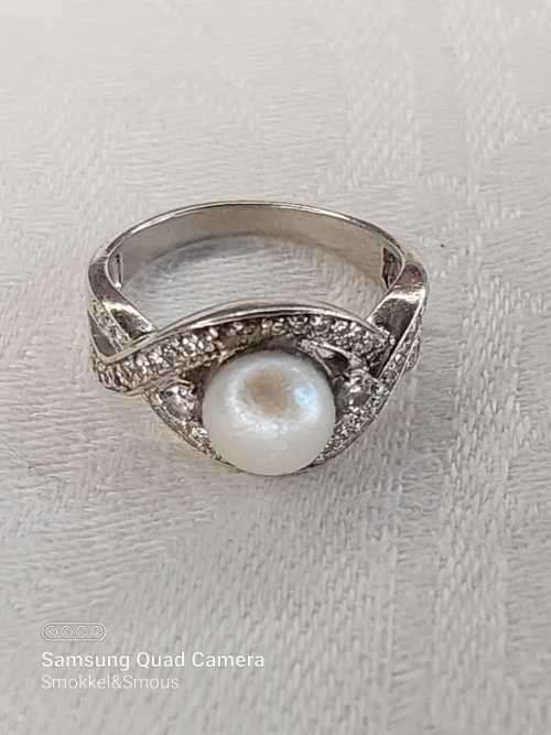 Sterling silver ladies ring with genuine pearl surrounded with cubic zirconia Size: O.5