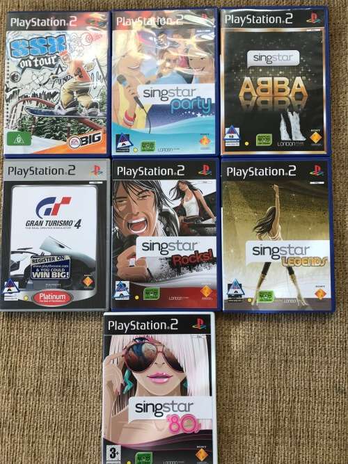 SONY PLAYSTATION 2 CONSOLE WITH 7 GAMES, 2 SINGSTAR MICROPHONES, 2 WIRED CONTROLS!!!!
