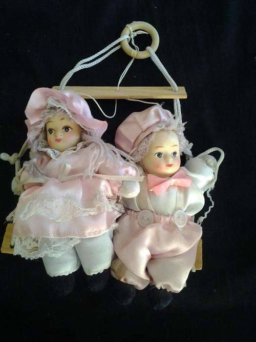 Pink doll on a swing