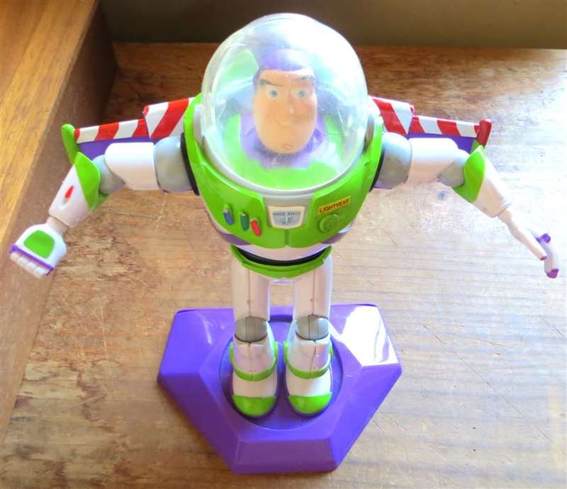 Large Disney Pixar Buzz Lightyear toy on stand