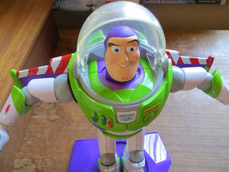 Large Disney Pixar Buzz Lightyear toy on stand