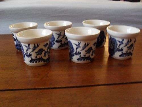 Six Willow Pattern Egg Cup Holders. made in England on the bottom of the egg cups.